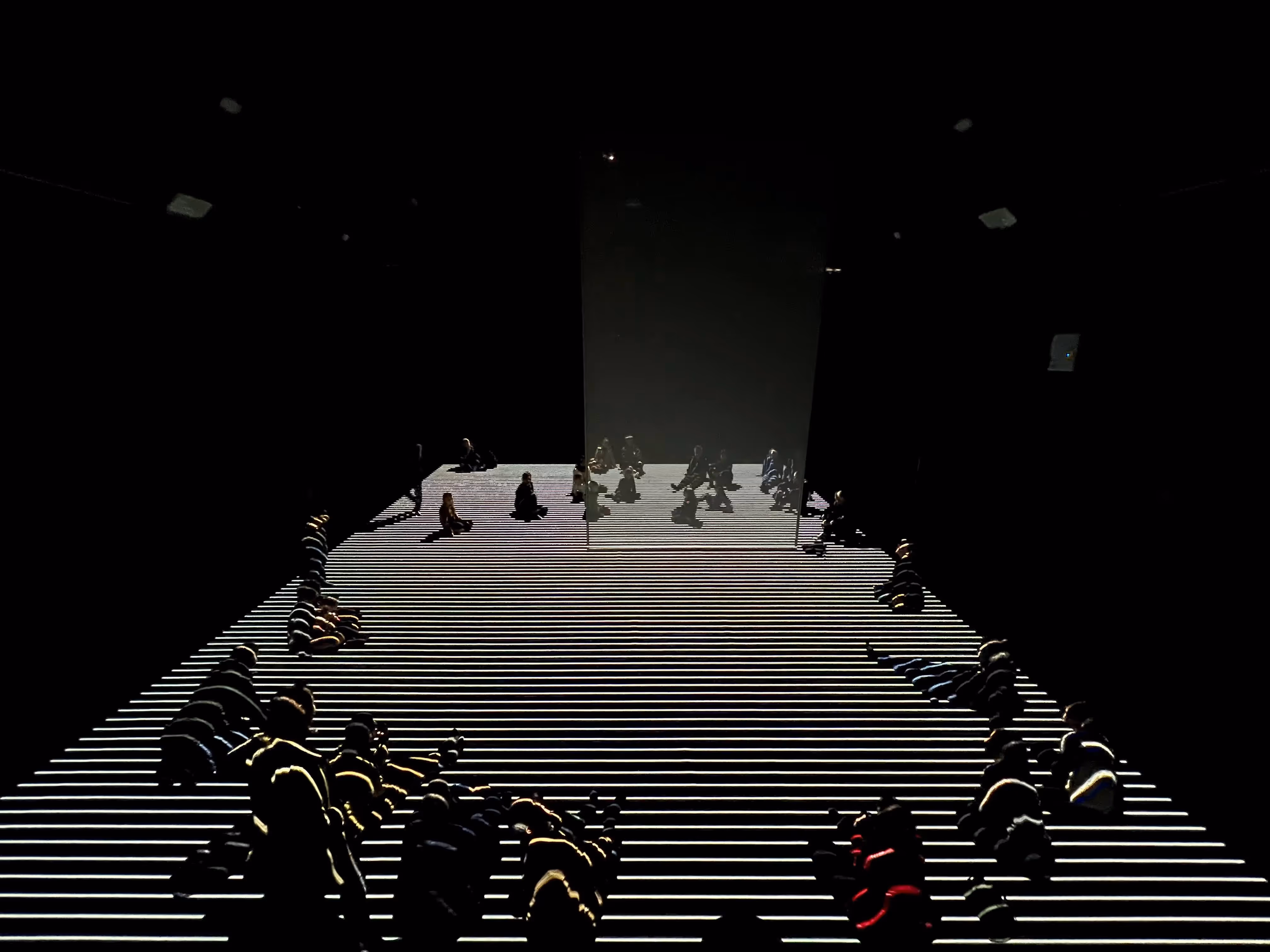 Festival di Spoleto performance with silhouetted performers on striped stage