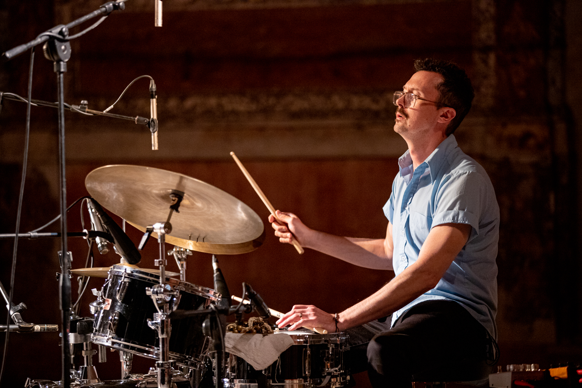 Drummer performing at Festival di Spoleto, captured mid-rhythm on stage