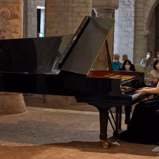 Pianist performing at Festival di Spoleto in historic stone venue