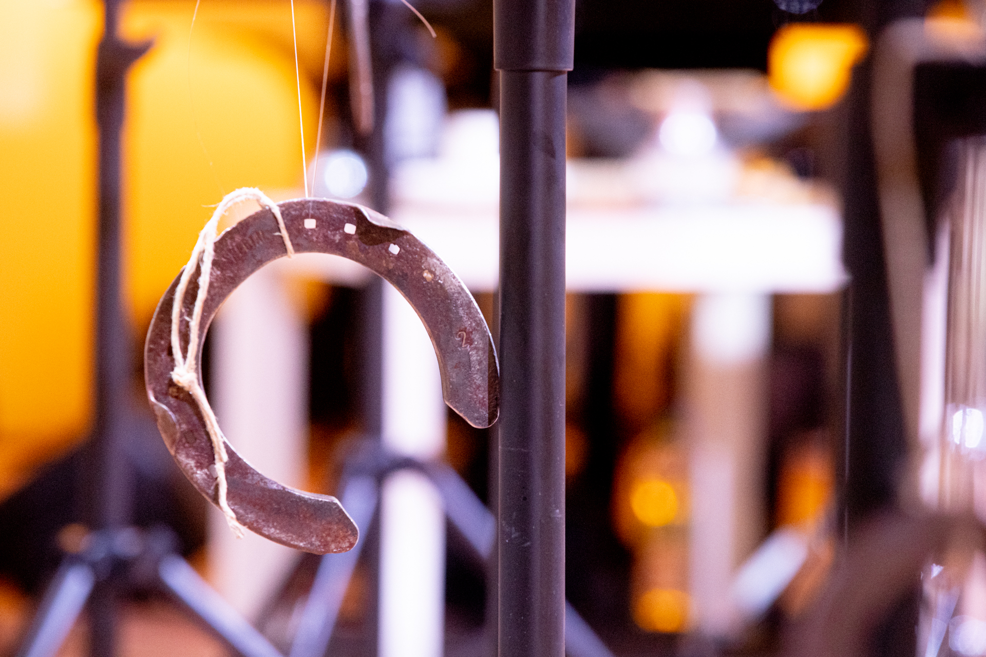 Rusty horseshoe hanging at Festival di Spoleto with blurred lights
