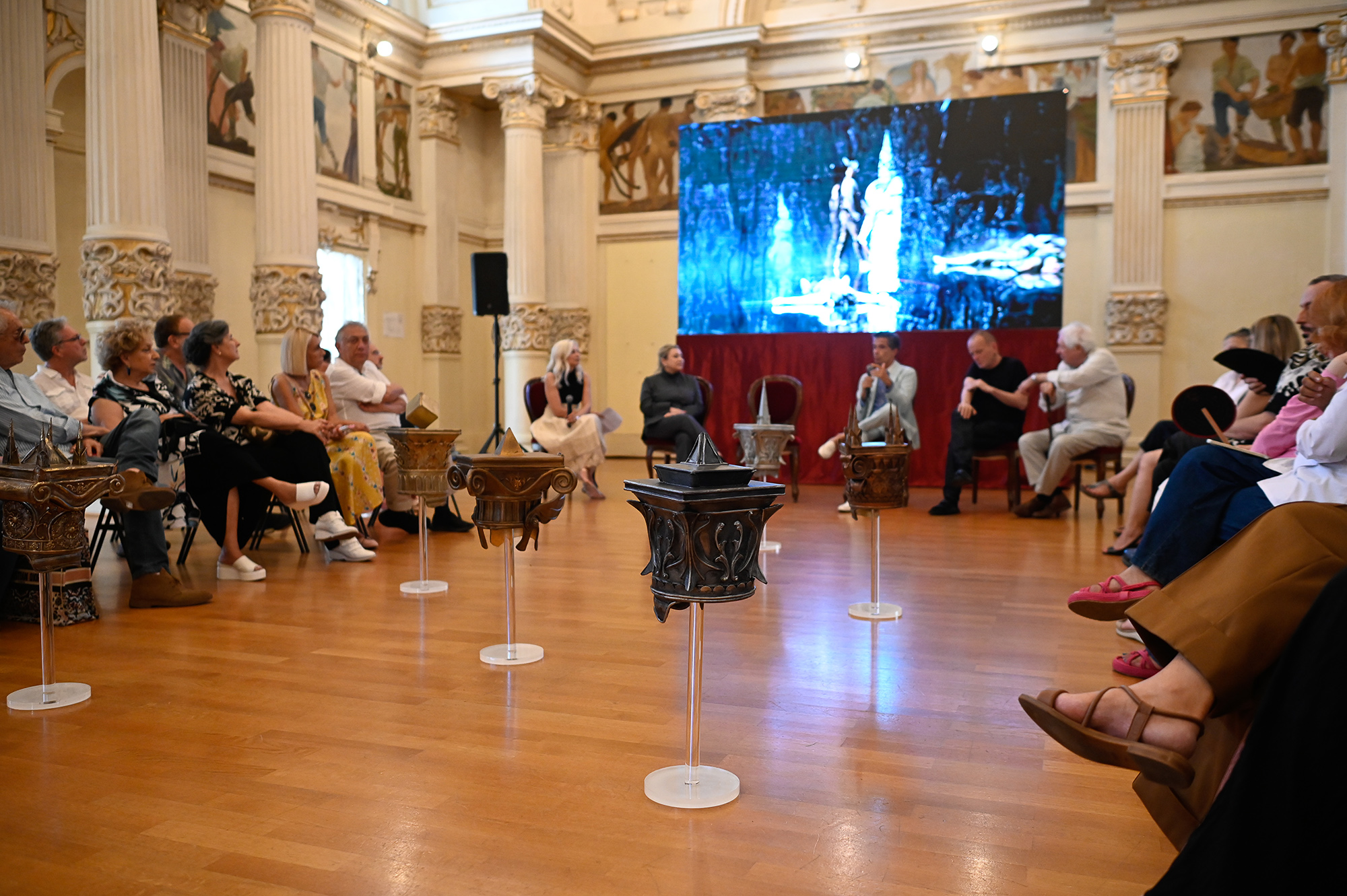 Festival di Spoleto event with audience and ornate vases in elegant hall