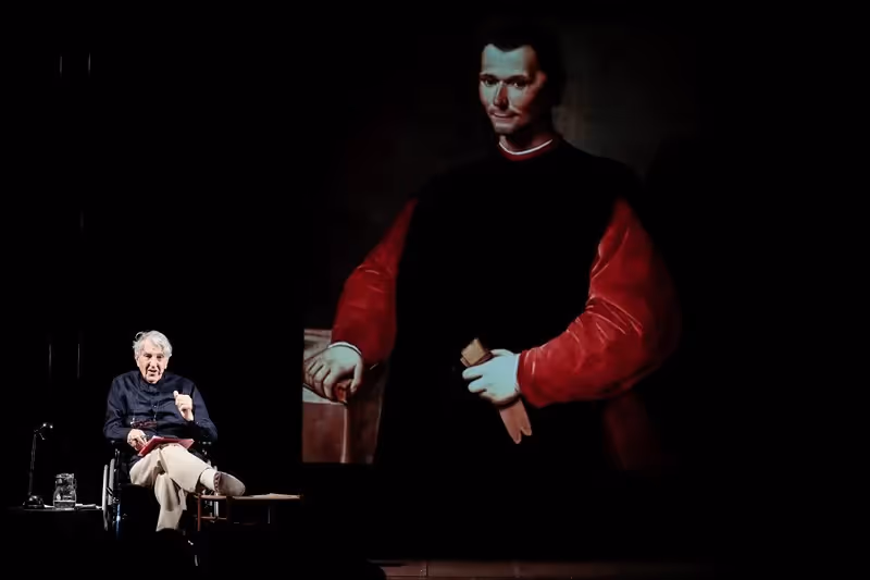 Festival di Spoleto performance with actor and dramatic portrait backdrop