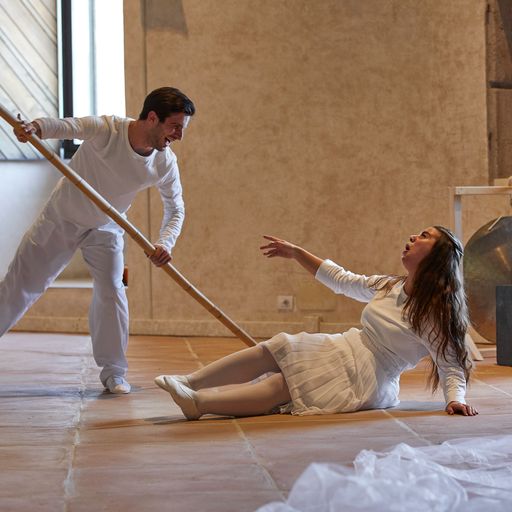 Festival di Spoleto performers in white, dramatic dance performance with stick