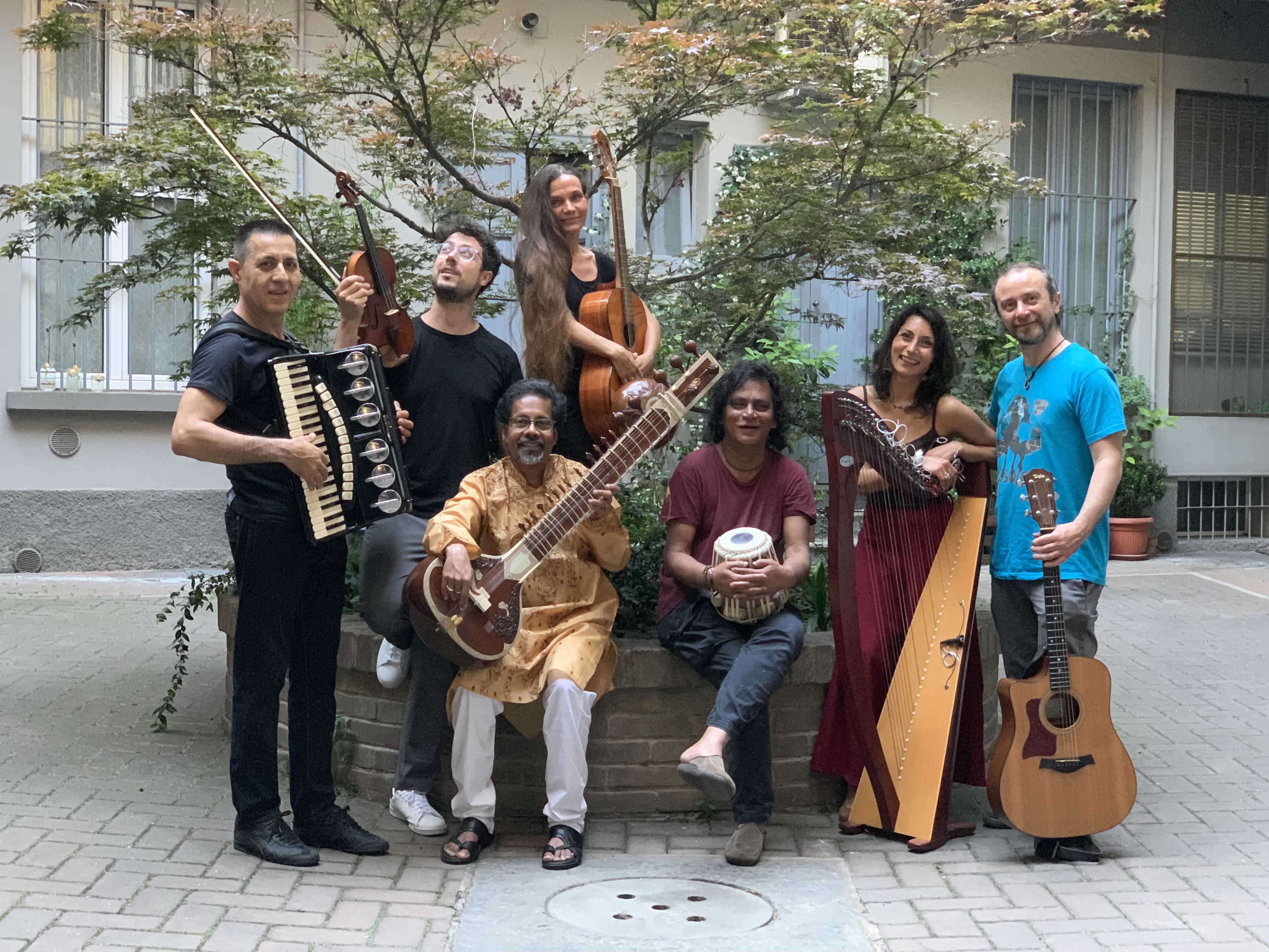 Diverse musicians with instruments pose at Festival di Spoleto event