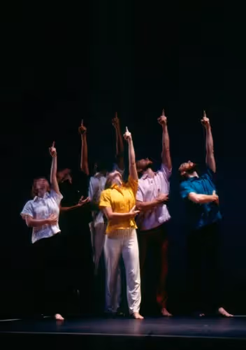 Performers al Festival di Spoleto, danzatori sincronizzati sul palcoscenico scuro