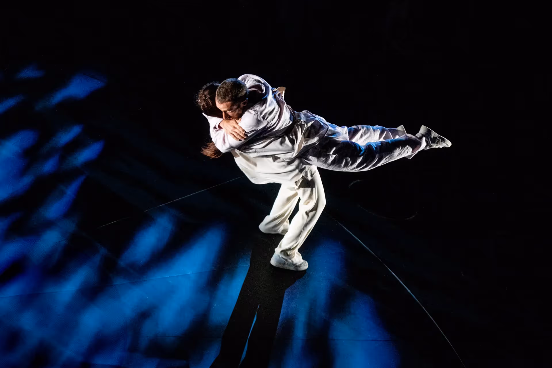 Emotional dance performance at Festival di Spoleto with dramatic blue lighting