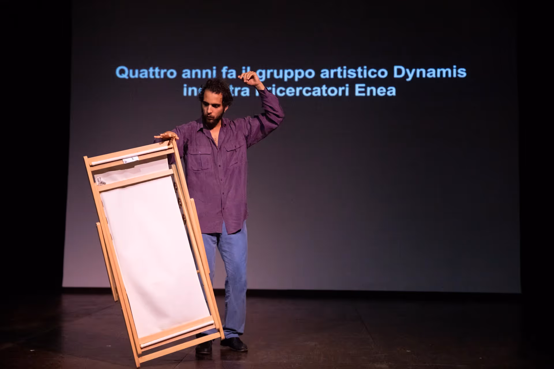 Performer at Festival di Spoleto with wooden easel on minimalist stage