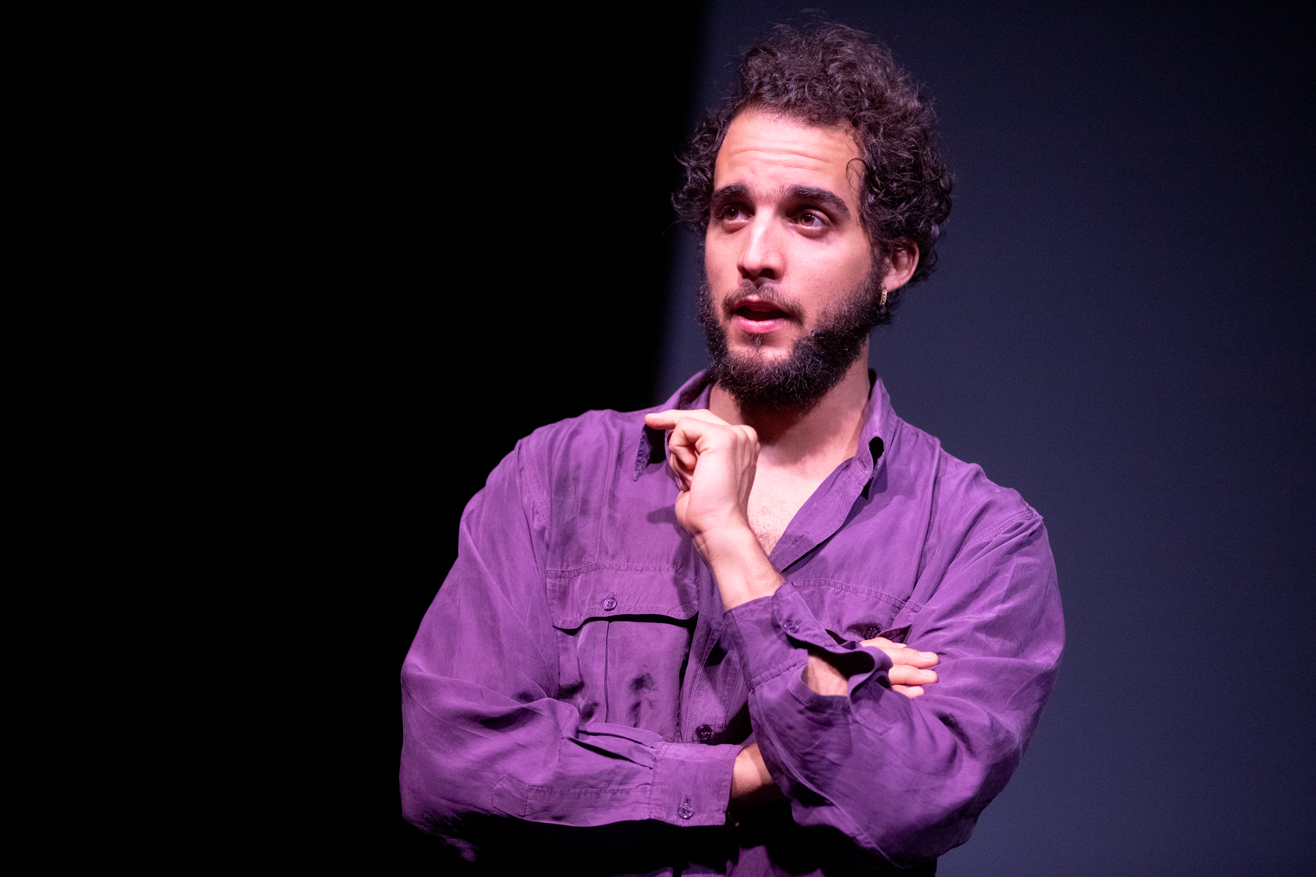 Attore in viola sul palco al Festival di Spoleto, espressivo e pensieroso