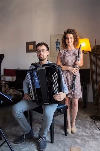 Musicians prepare for Festival di Spoleto, accordionist and oboist pose together