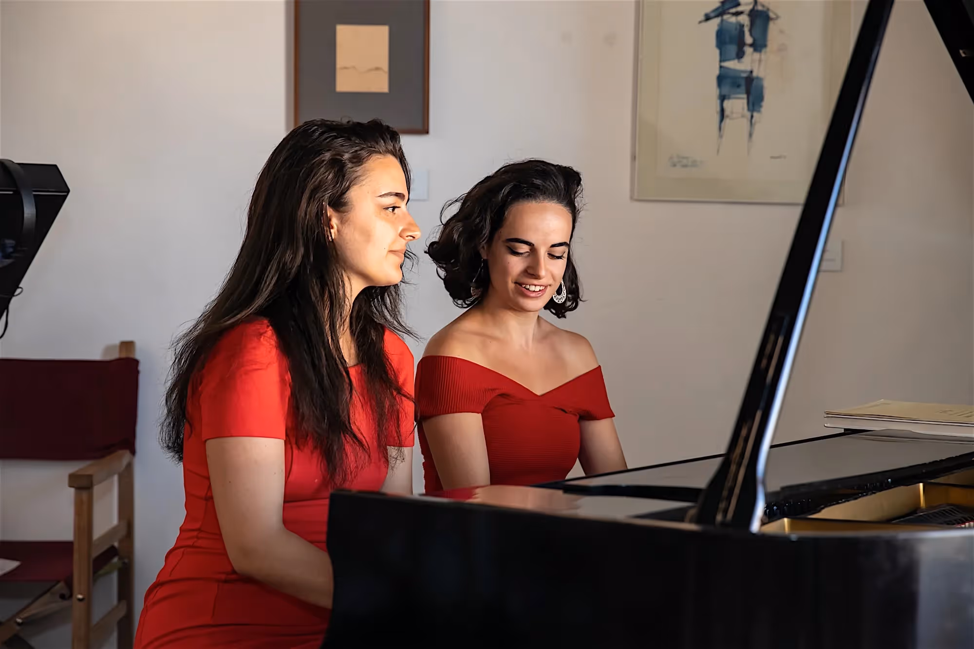 Two musicians in red dresses prepare for Festival di Spoleto performance