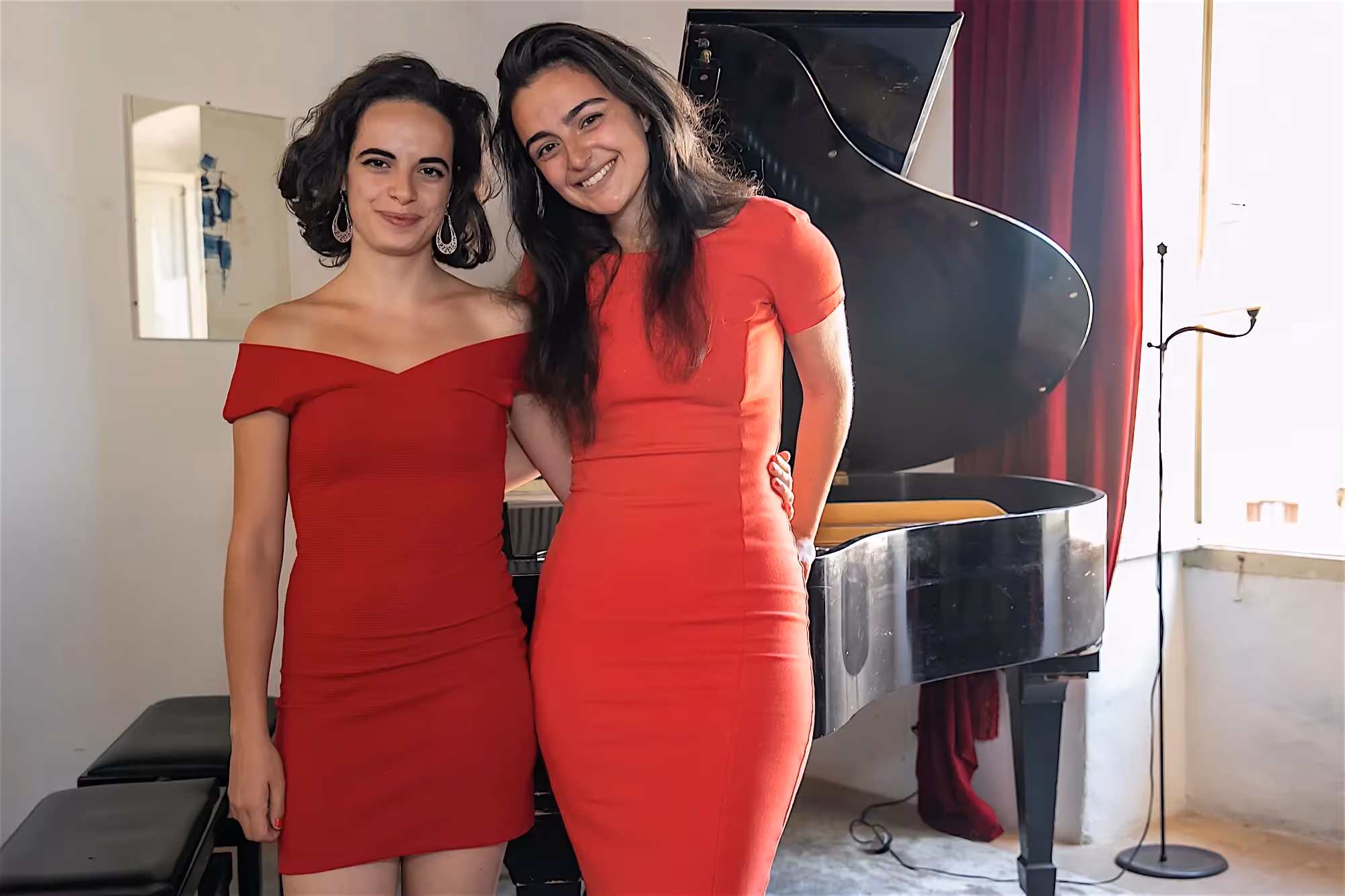 Two performers in red dresses at Festival di Spoleto musical event
