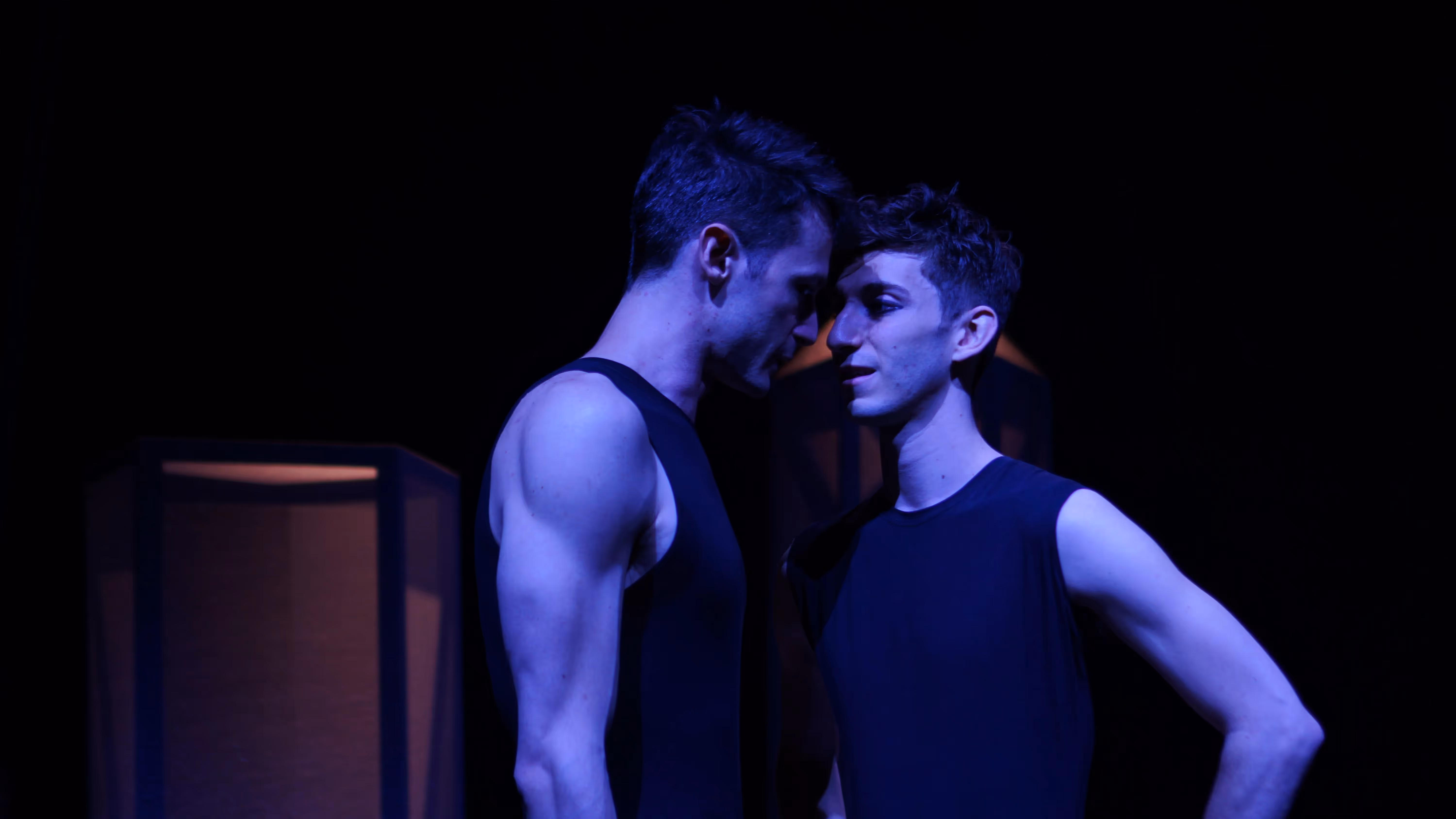 Two performers in blue light at Festival di Spoleto dance performance