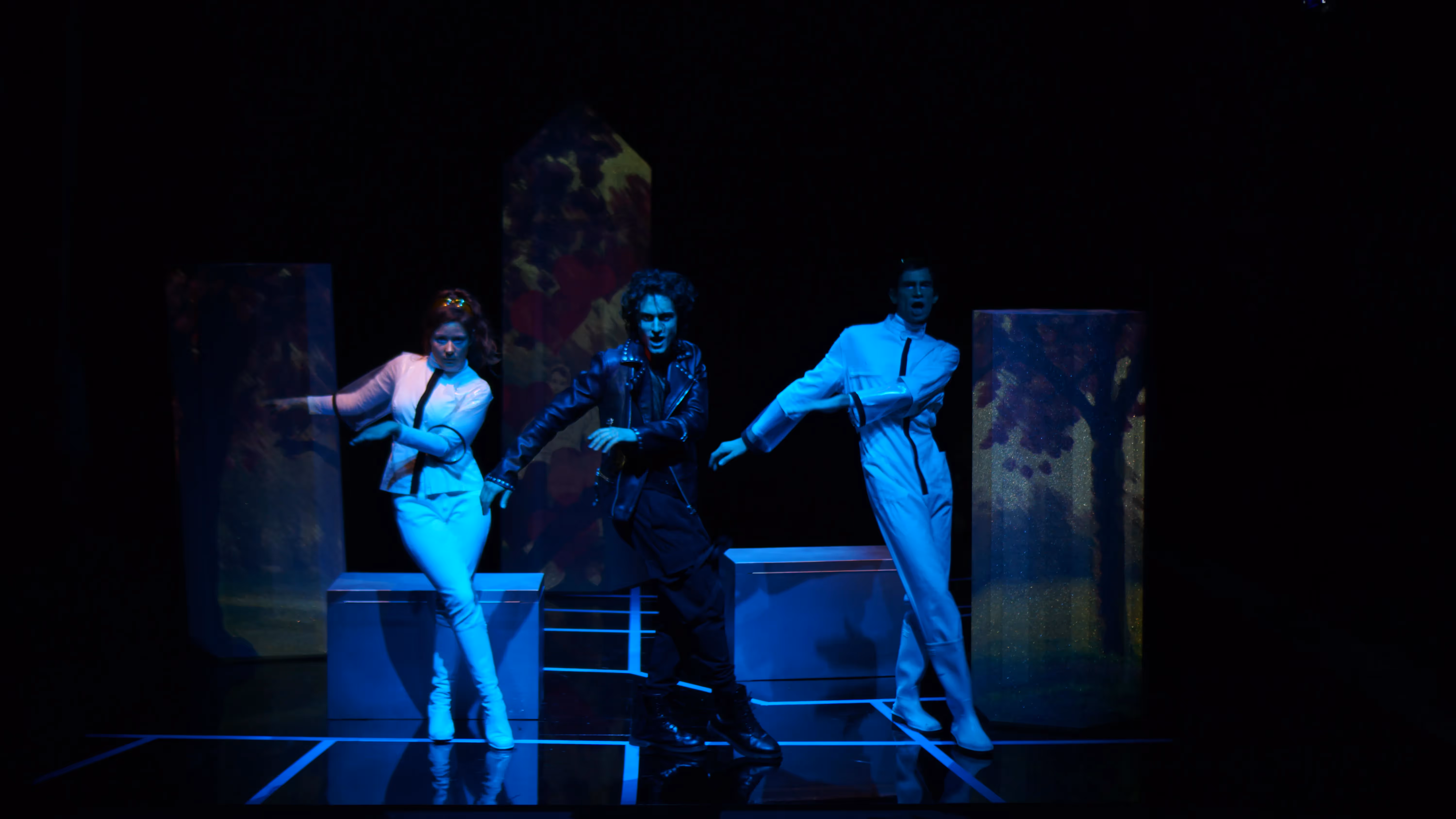 Festival di Spoleto performance with three dancers in blue-lit theatrical stage