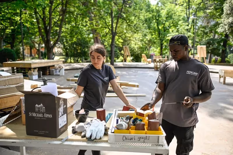 Festival di Spoleto staff preparing materials in a leafy outdoor workspace