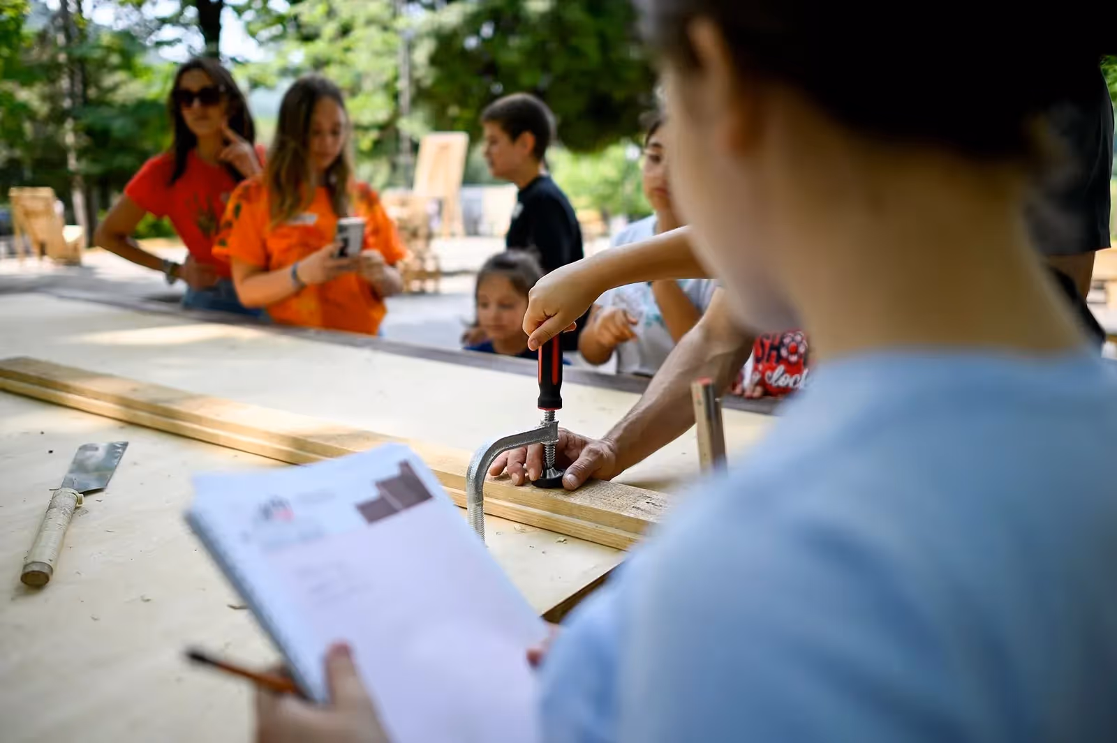 Festival di Spoleto workshop with children learning crafting skills outdoors
