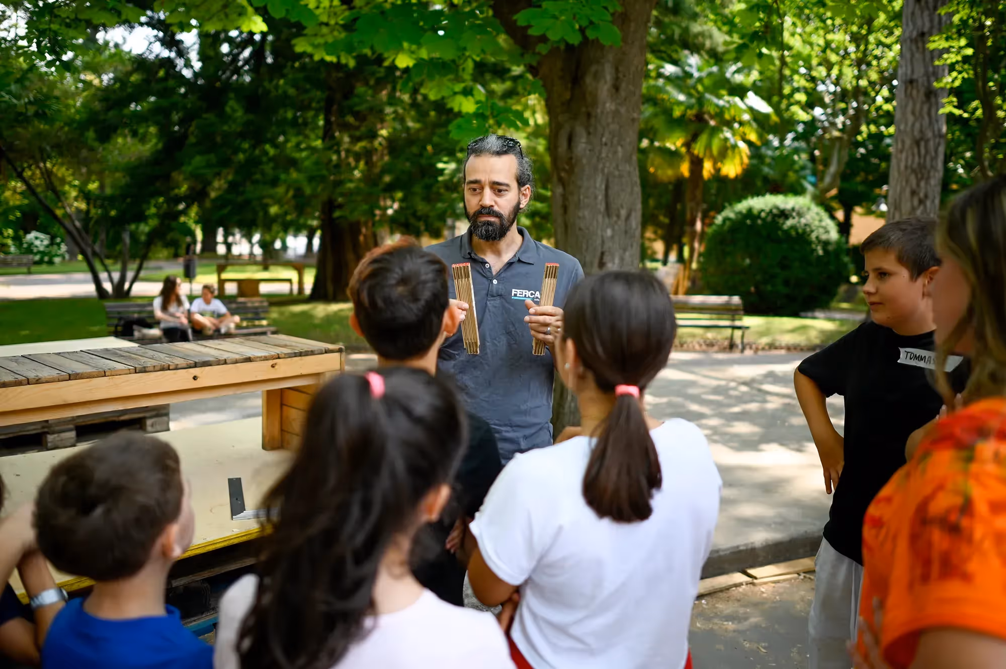 Festival di Spoleto workshop with children learning percussion in a park