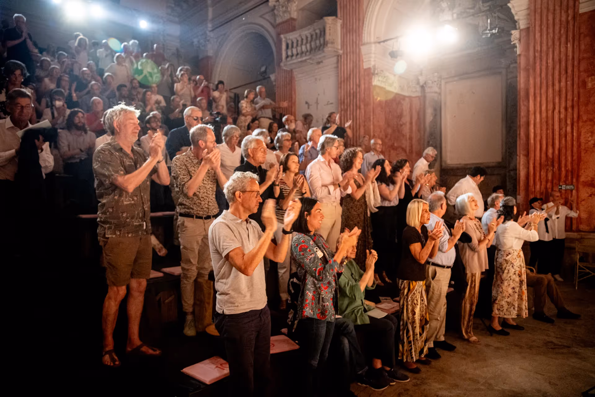 Audience applauding at Festival di Spoleto performance in historic theater