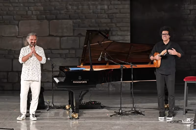 Festival di Spoleto musicians perform with piano and acoustic guitar on stone stage