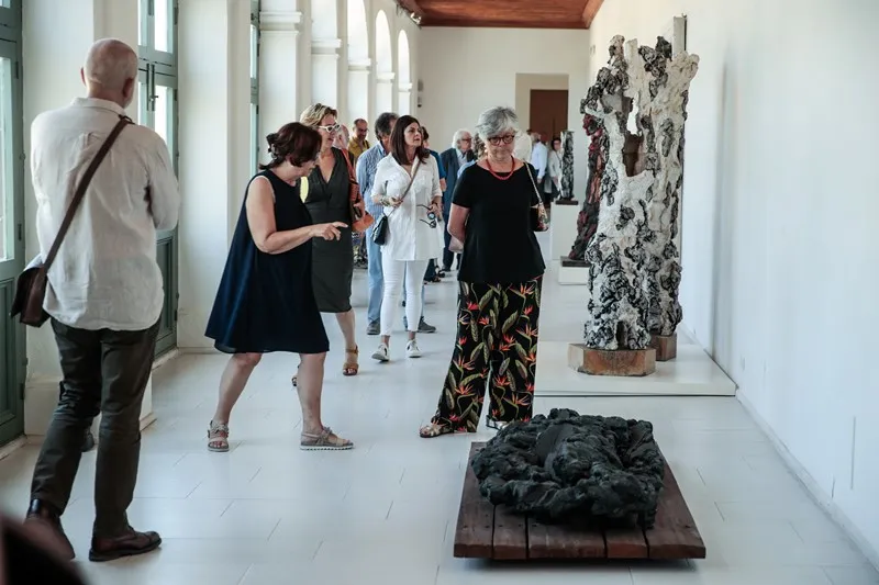 Visitors explore art exhibition at Festival di Spoleto cultural gallery