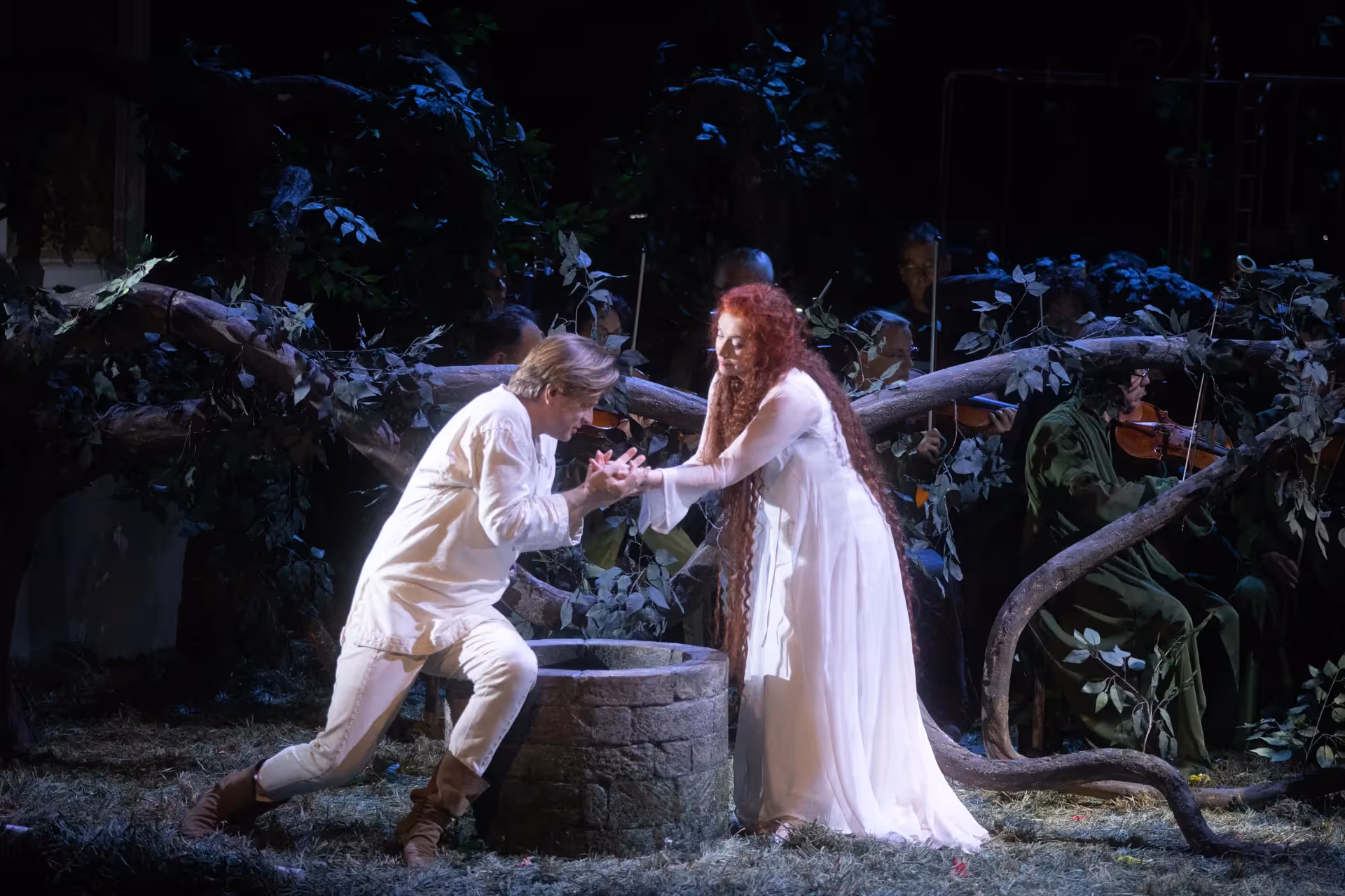 Festival di Spoleto performance of romantic theatrical scene near stone well