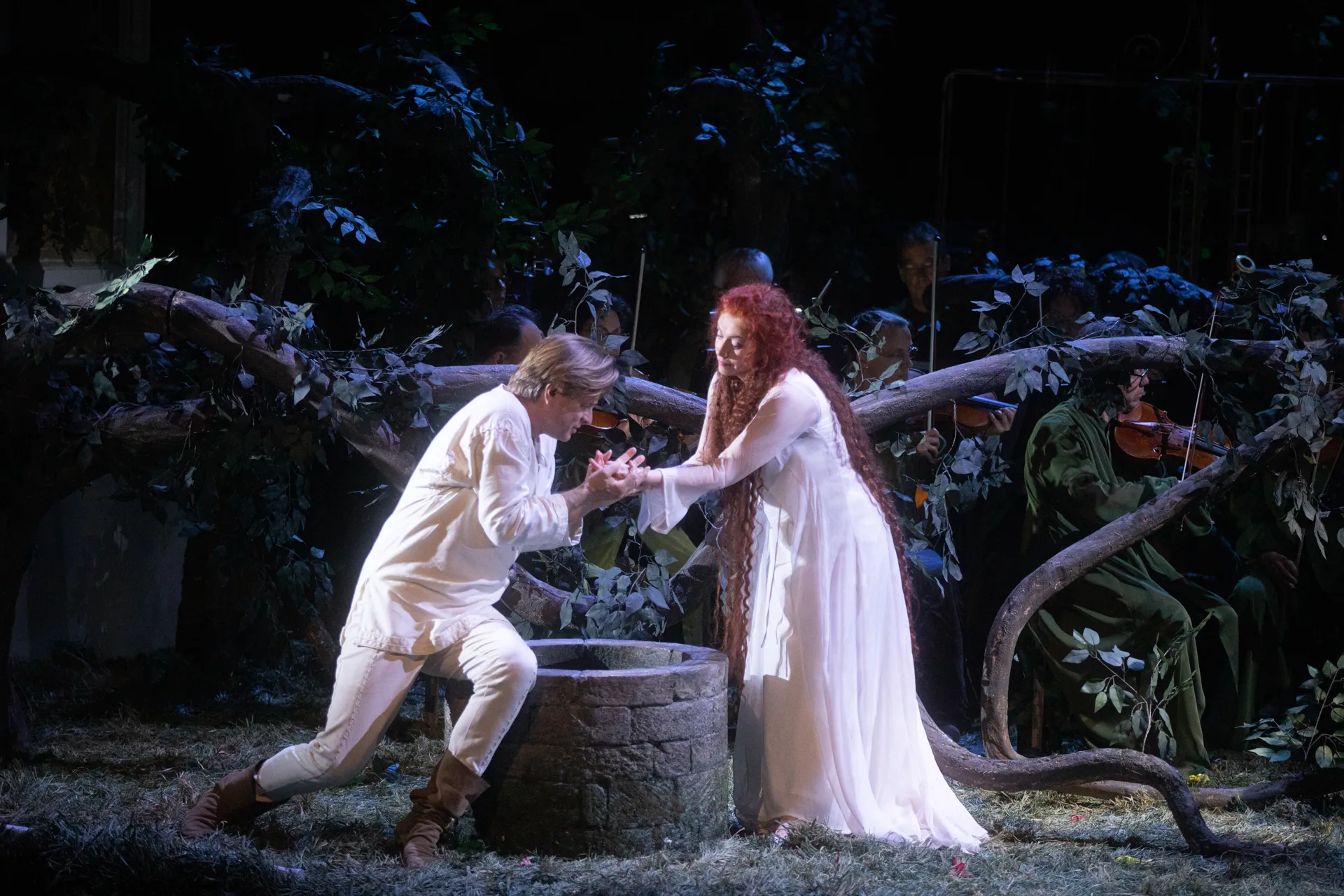 Festival di Spoleto performance of romantic theatrical scene near stone well