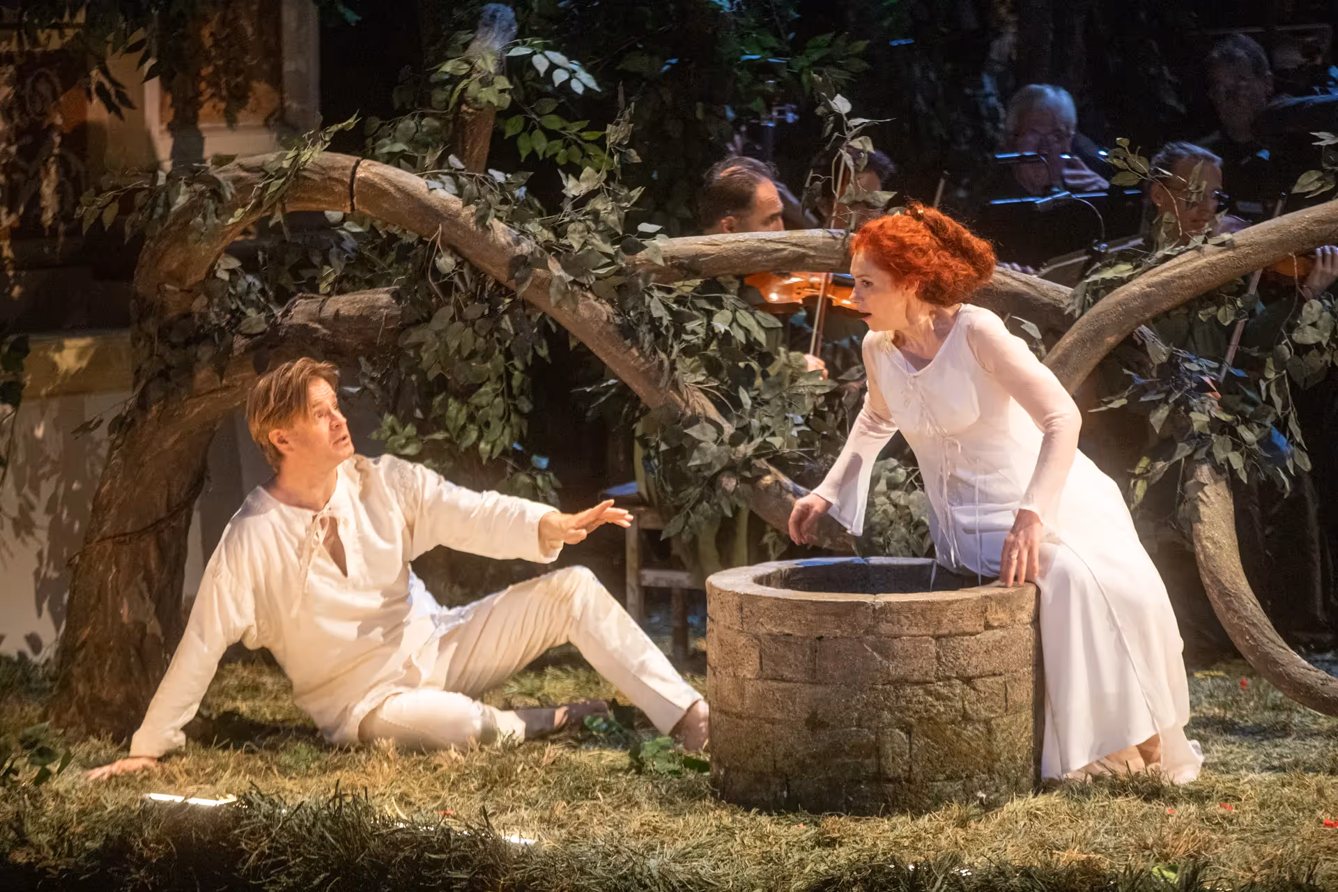 Festival di Spoleto theatrical performance with actors in white near stone well