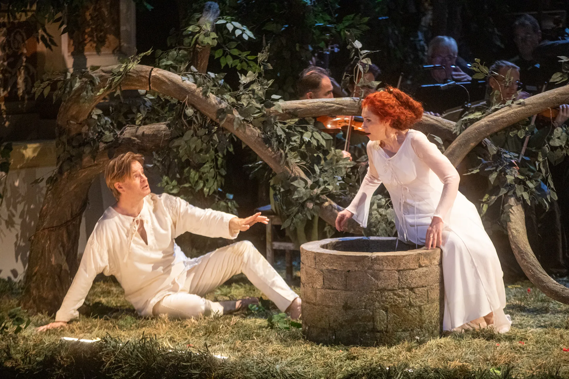 Festival di Spoleto theatrical performance with actors in white near stone well