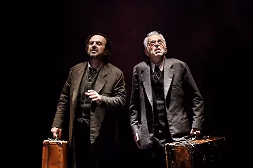 Two men with vintage suitcases on stage at Festival di Spoleto theater performance