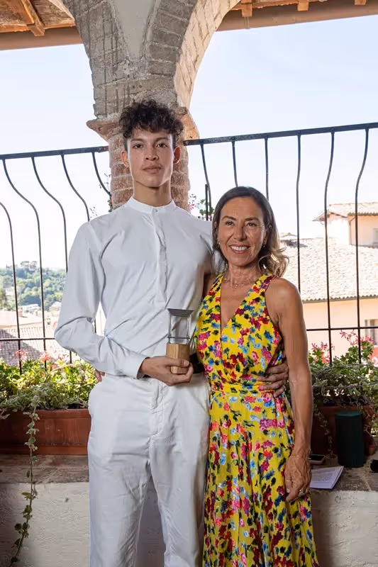 Festival di Spoleto award ceremony with winner in white and smiling woman