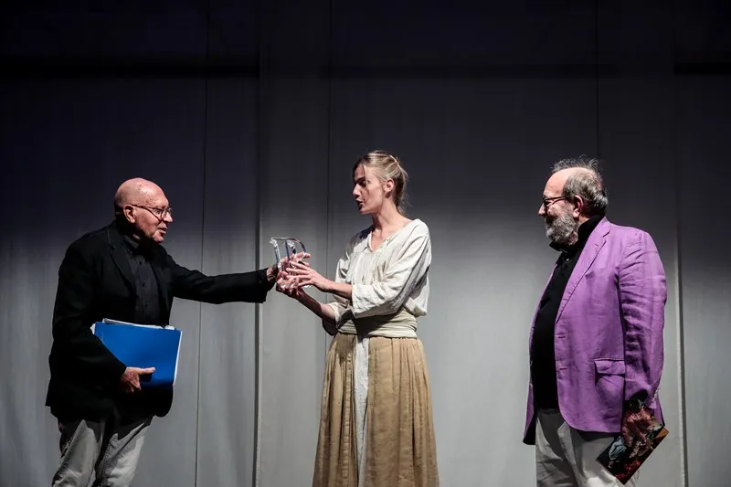 Three actors performing on stage at Festival di Spoleto theatrical production