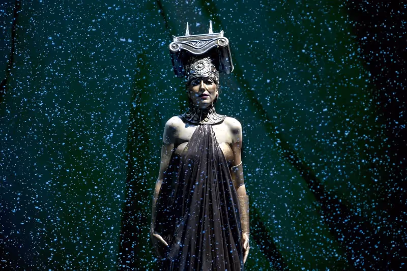 Theatrical performer at Festival di Spoleto, adorned in elaborate costume and headdress