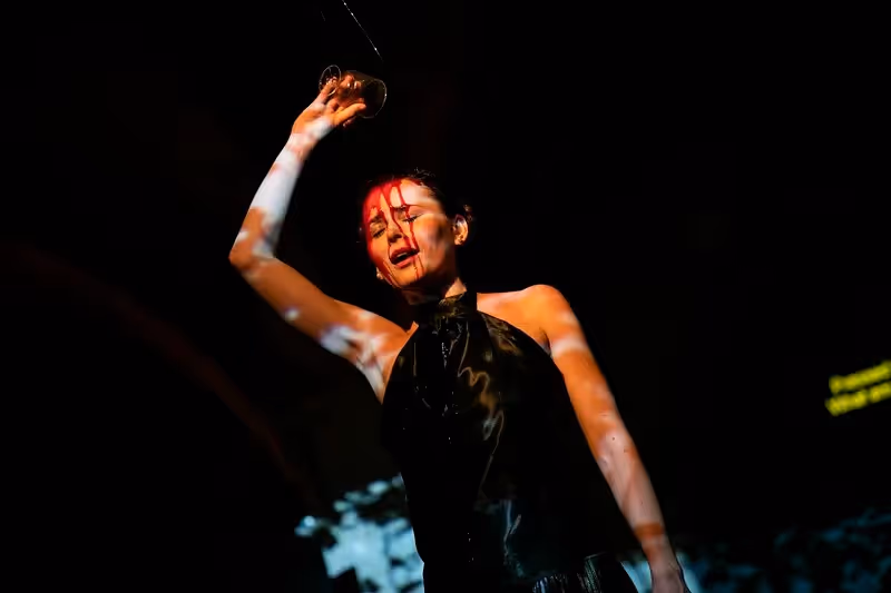 Dramatic performance at Festival di Spoleto featuring expressive dancer with red lighting
