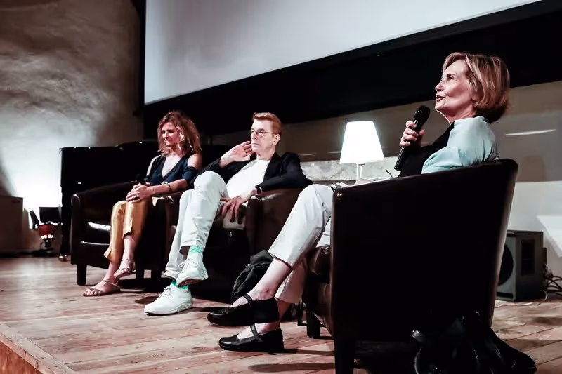Panel discussion at Festival di Spoleto featuring three speakers on stage
