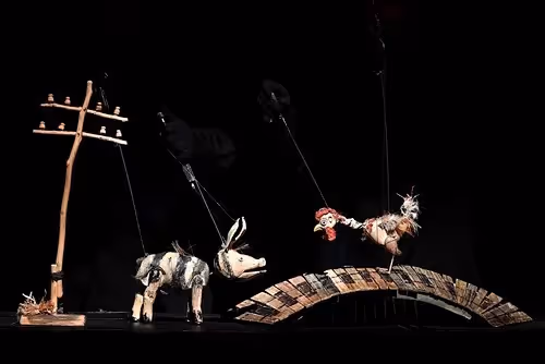 Surreal puppetry scene at Festival di Spoleto with animals on abstract stage