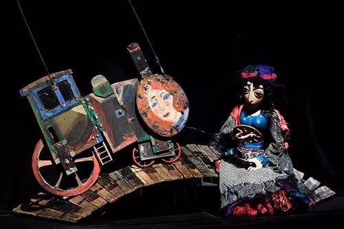 Colorful Festival di Spoleto puppet theater display with artistic carriage and doll