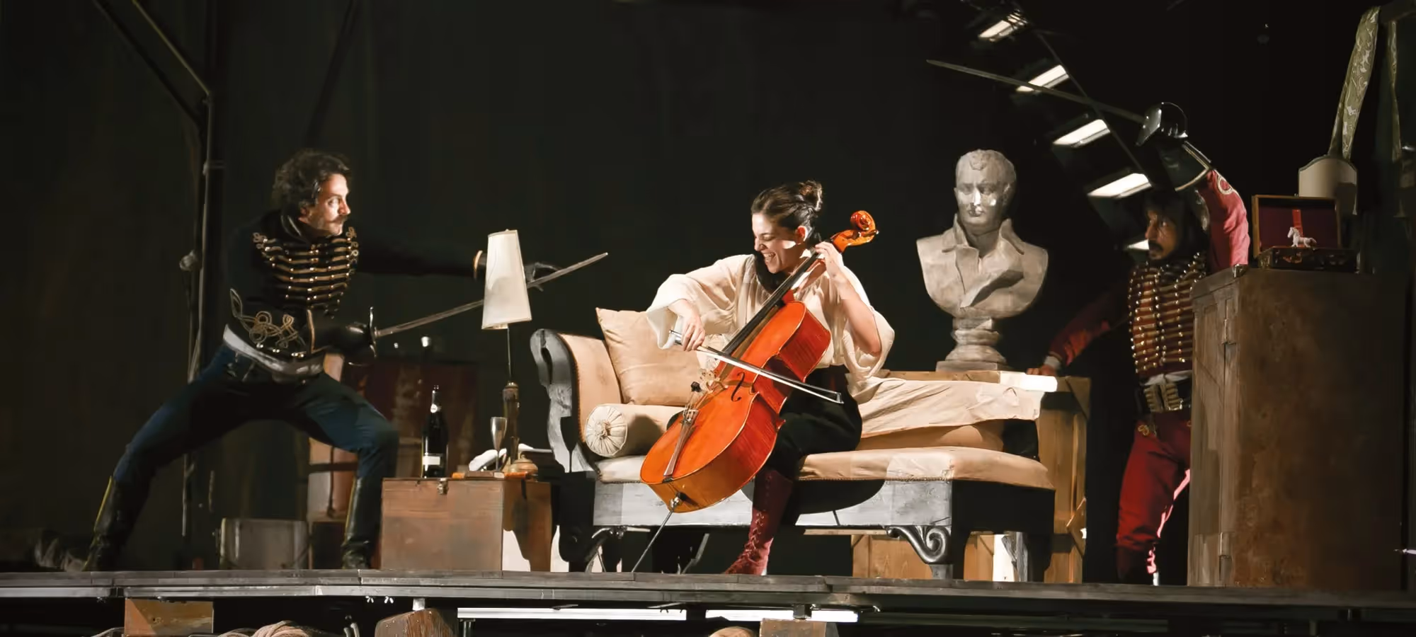 Festival di Spoleto performance with cellist on stage amid theatrical props