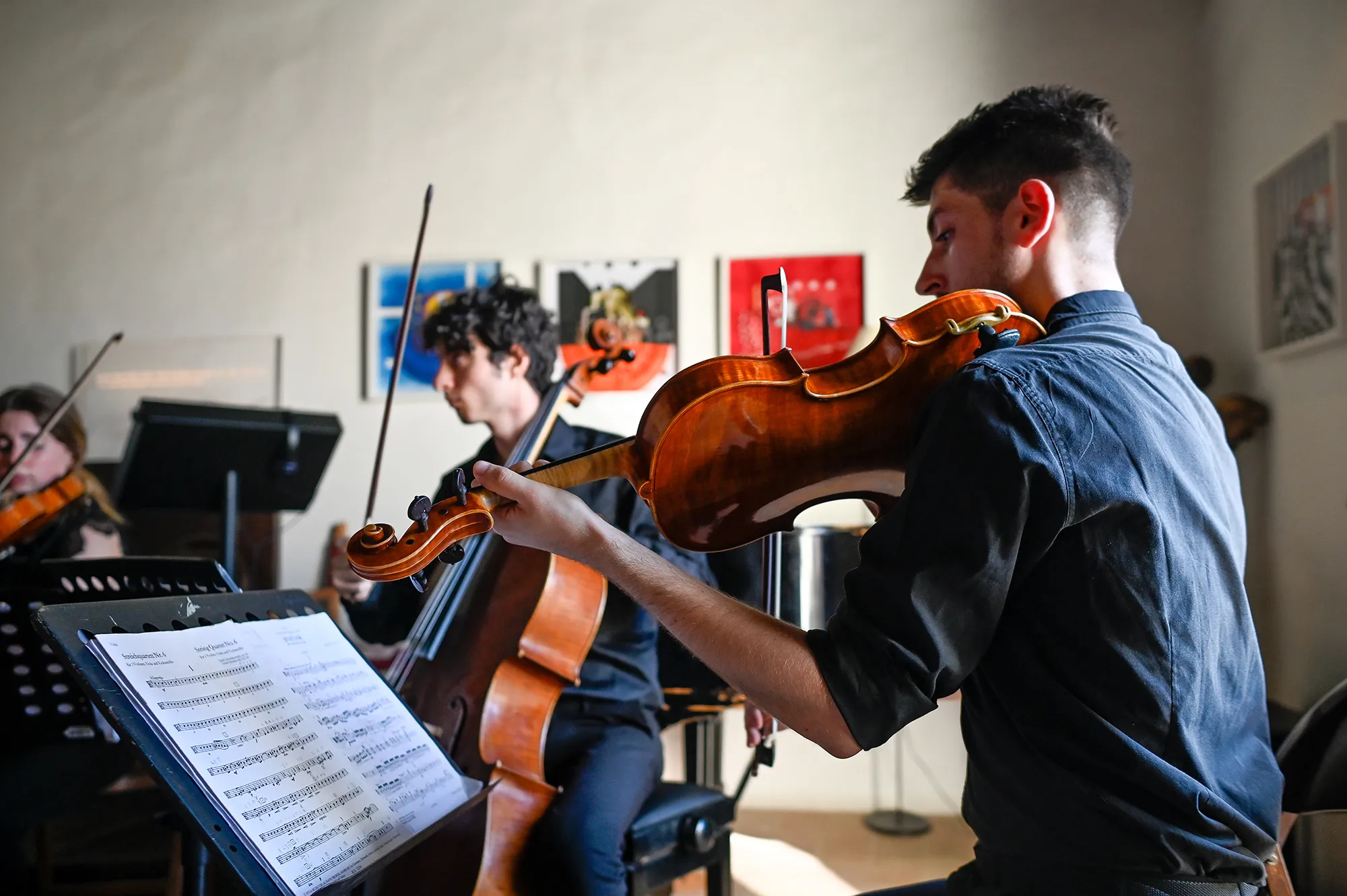 Musicians prepare for Festival di Spoleto, playing violins with sheet music