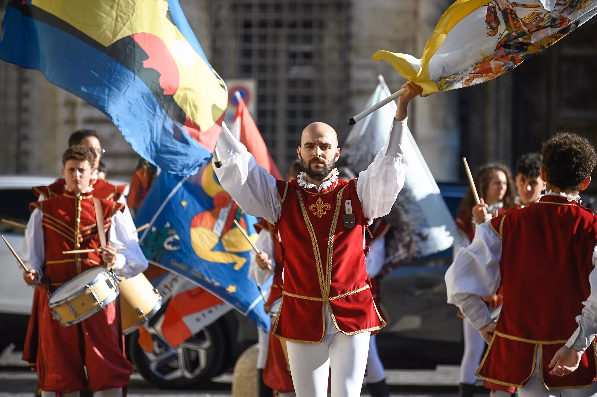 Festival di Spoleto performers in vibrant red and white historical costumes