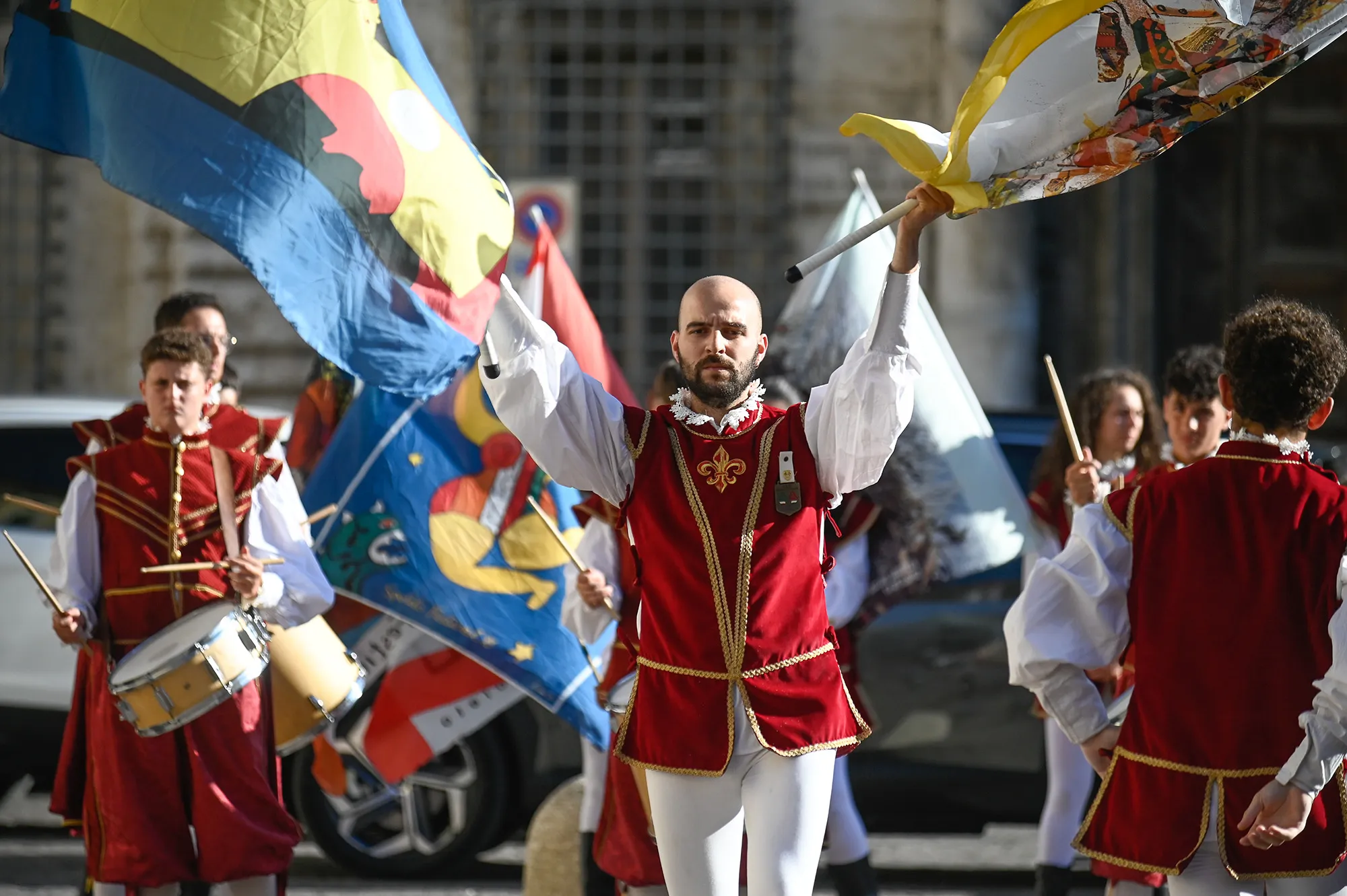 Festival di Spoleto performers in vibrant red and white historical costumes