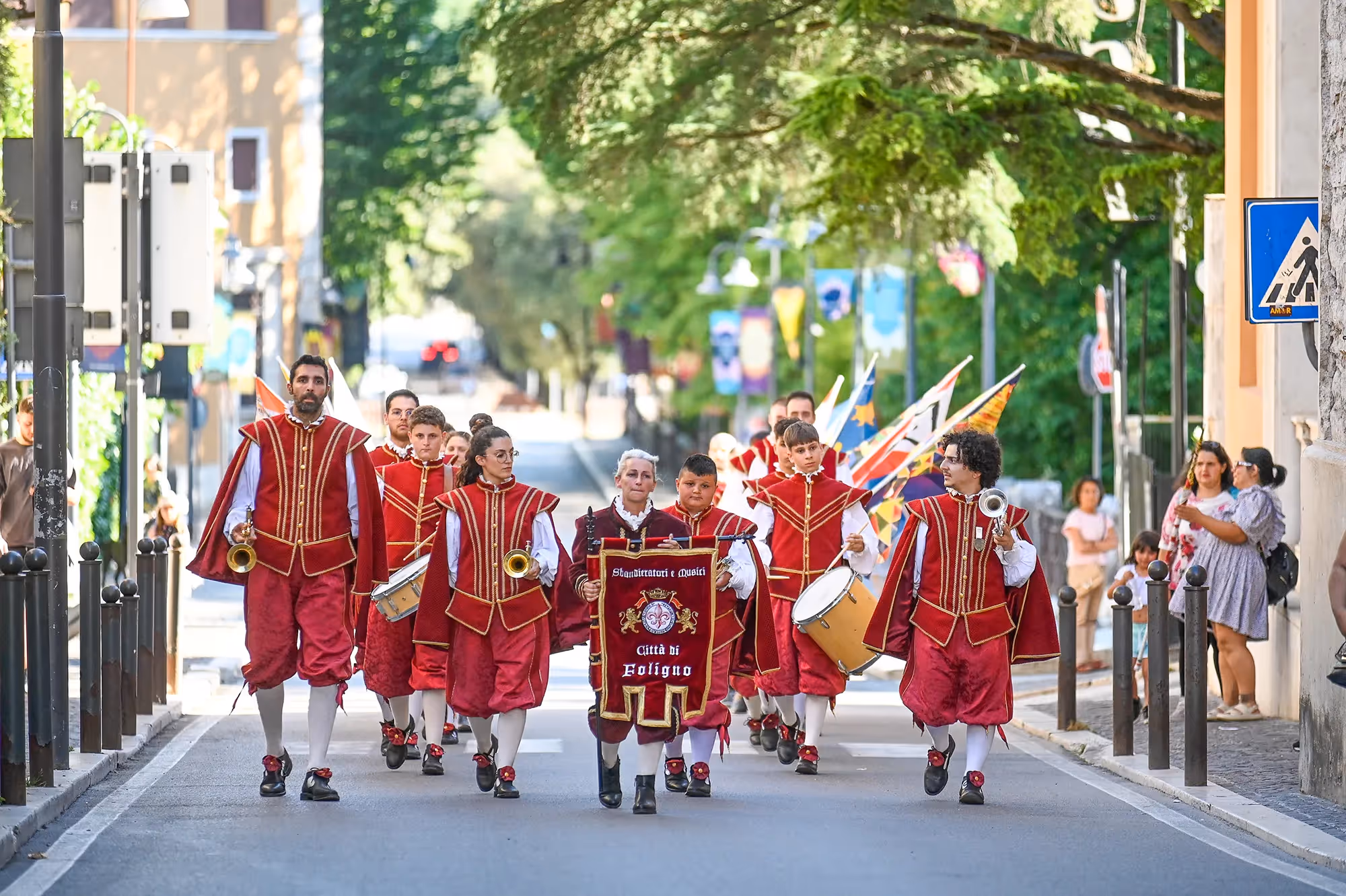 Festival di Spoleto parade with musicians in red historical costumes marching