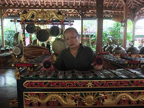 Musician plays traditional gamelan instruments at Festival di Spoleto cultural event