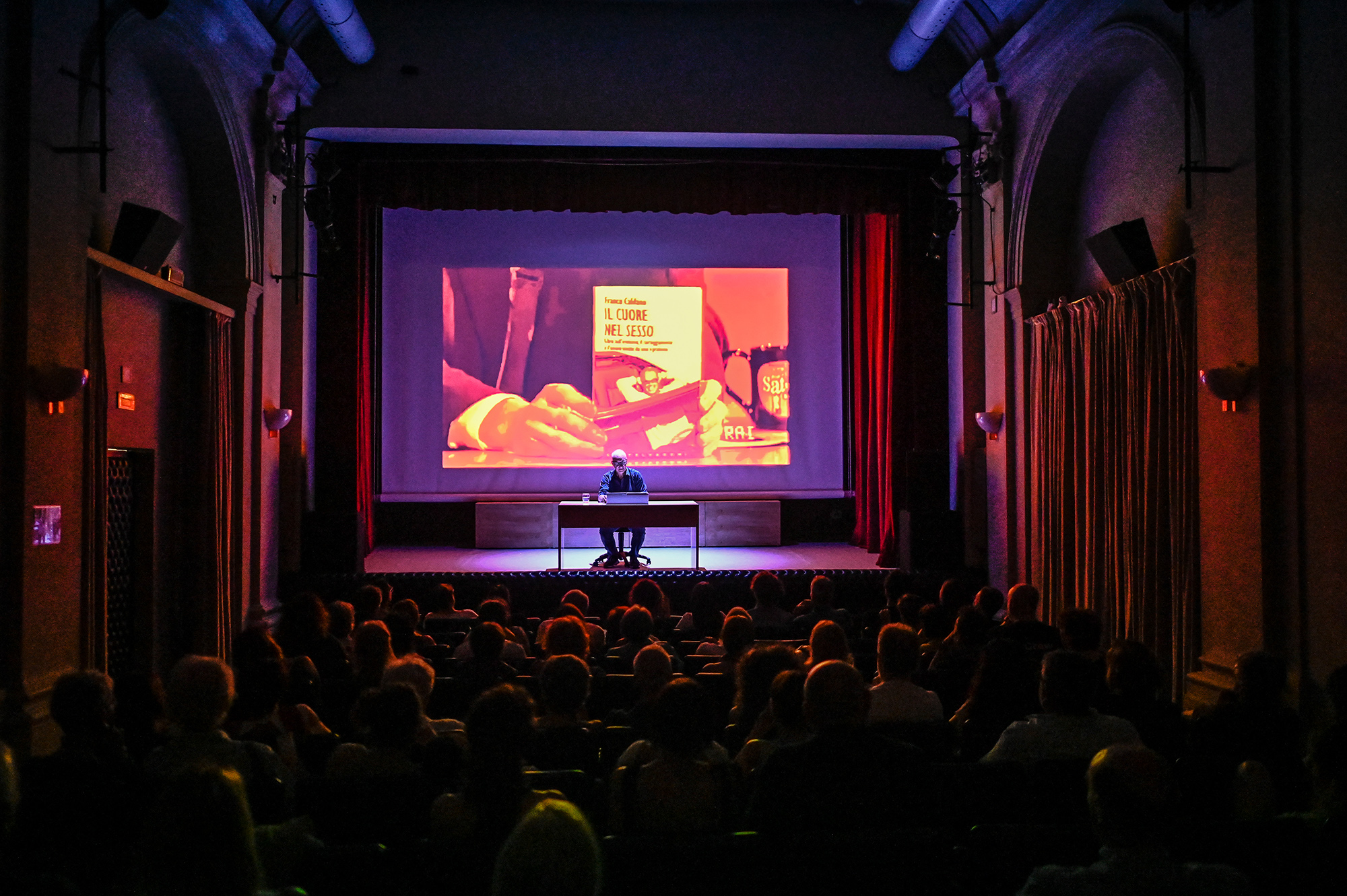 Festival di Spoleto event featuring book presentation on stage with audience