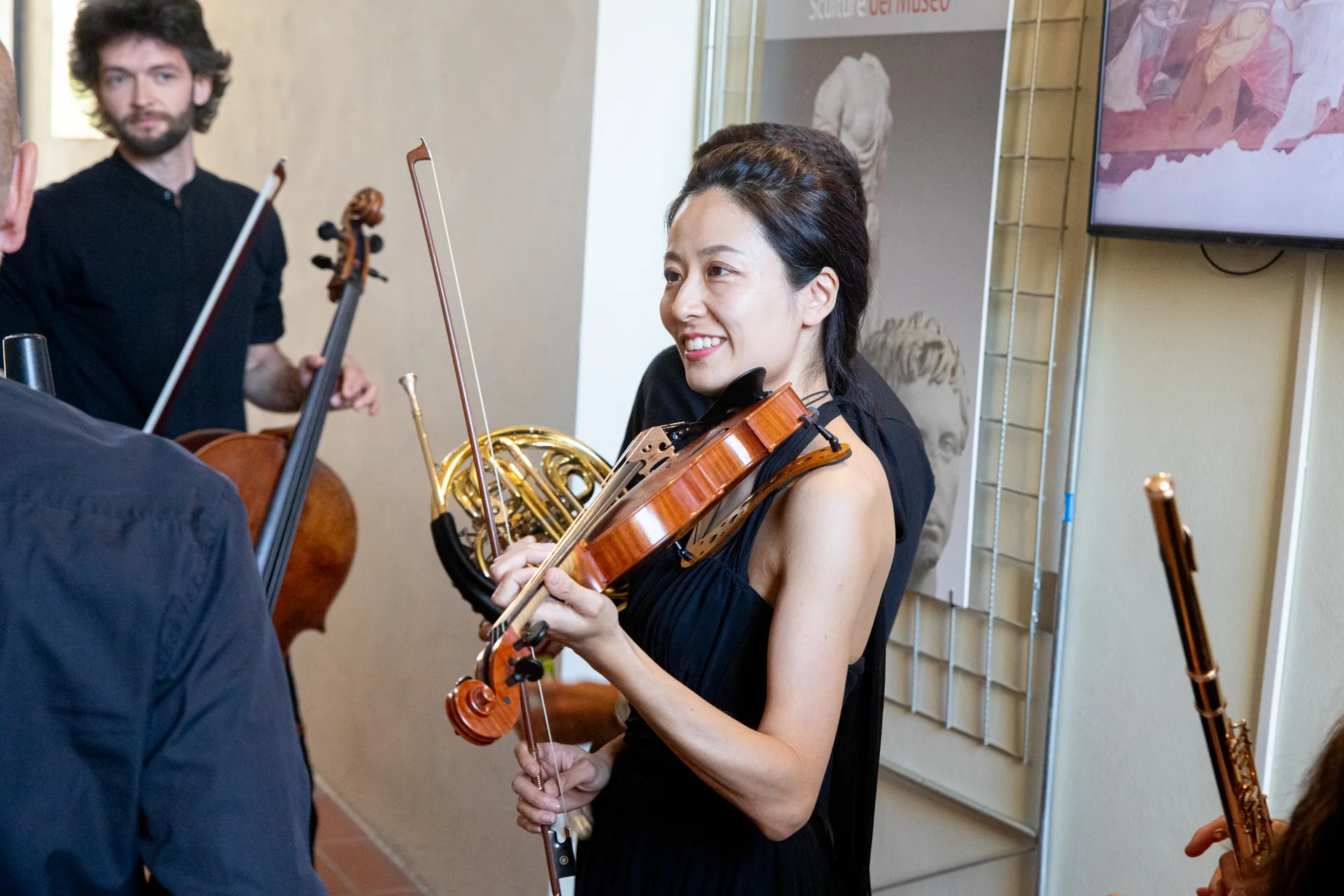 Musicians prepare for Festival di Spoleto, holding violin and French horn