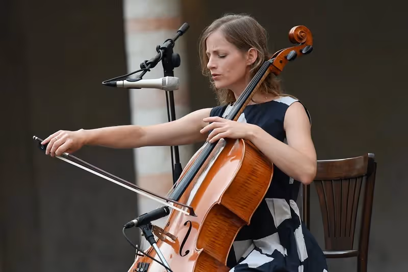 Cellist performing at Festival di Spoleto, focused and elegant on stage