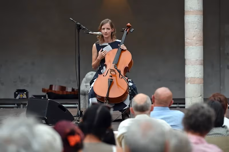 Cellist performing at Festival di Spoleto, captivating audience with musical performance