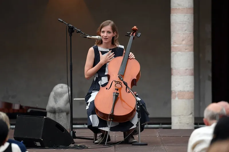 Cellist performing at Festival di Spoleto, elegant in black and white dress