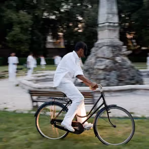 Person cycling at Festival di Spoleto near historic stone monument