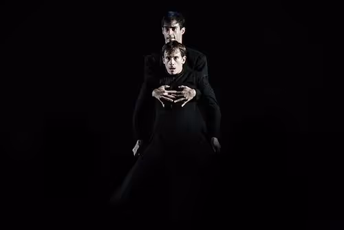Festival di Spoleto dramatic black performance with two figures in dark costumes