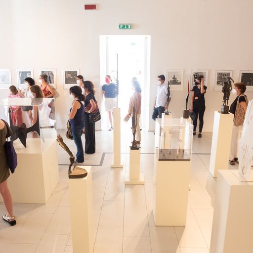 Festival di Spoleto art exhibition with visitors exploring sculptures and artworks