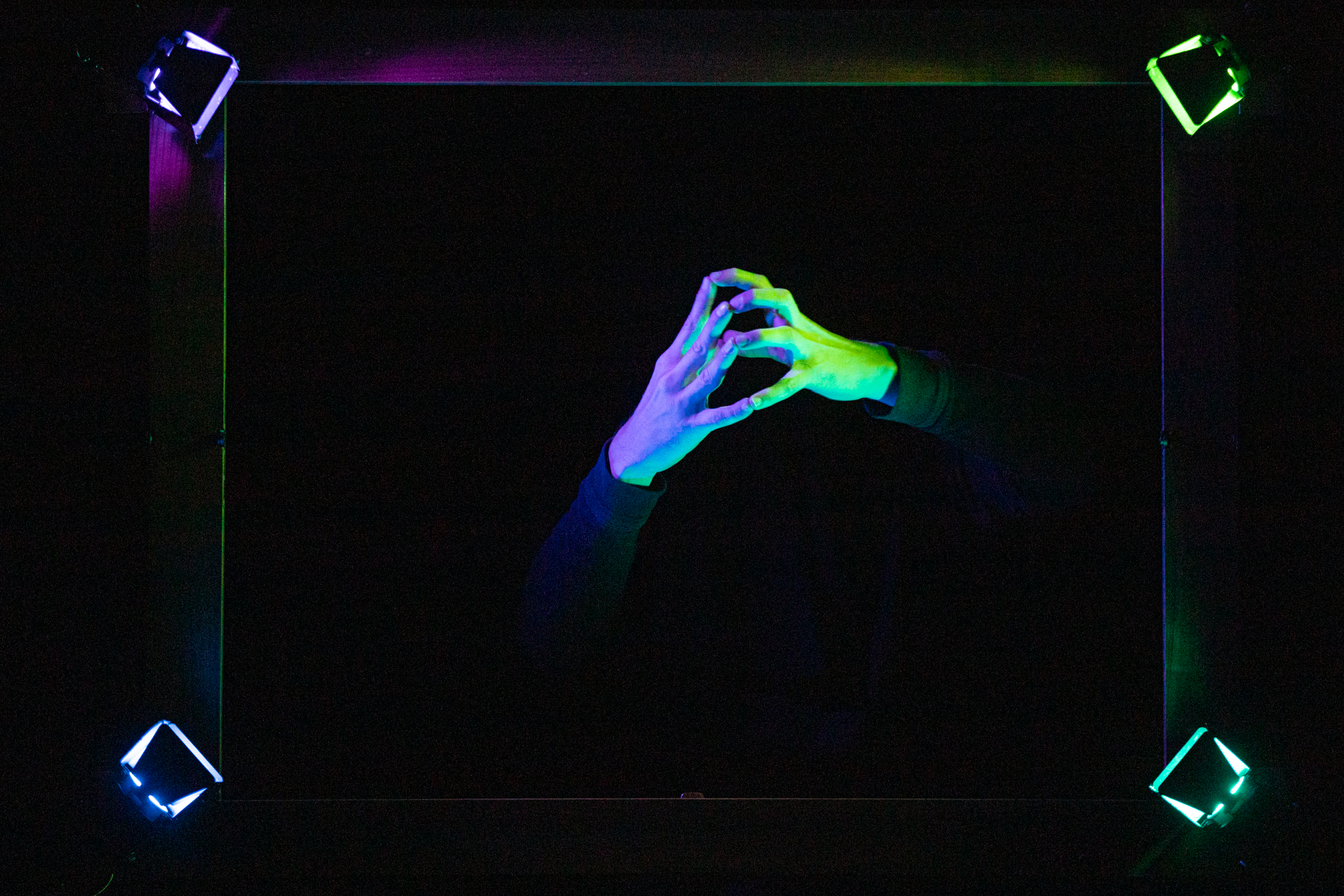 Festival di Spoleto abstract performance art with colorful illuminated hands